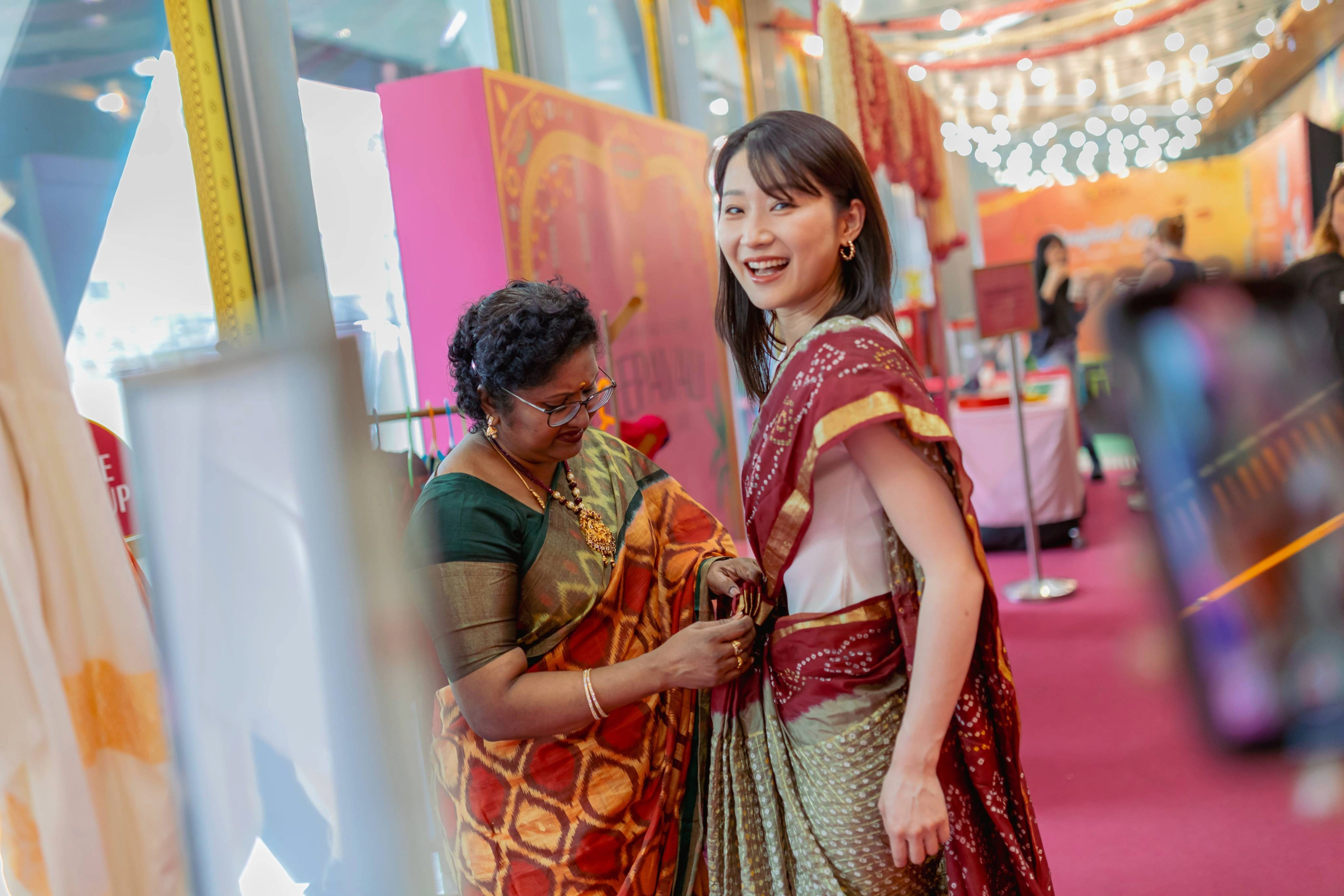 Women being dressed up in saree